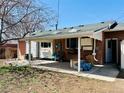 A covered backyard patio area offering a perfect spot for outdoor relaxation at 2964 S Yates St, Denver, CO 80236
