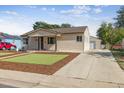 Inviting single-story home with a well-manicured lawn and convenient detached garage at 970 S Canosa Ct, Denver, CO 80219