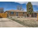 A charming brick house with well-kept landscaping, driveway, and fenced backyard at 1781 Uinta St, Denver, CO 80220