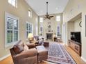 Cozy living room with a fireplace, large windows, and comfortable seating perfect for relaxing at 9246 Sori Ln, Highlands Ranch, CO 80126