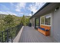Relax on this deck with a storage bench and a lovely wooded view at 960 Aspen Pl, Evergreen, CO 80439