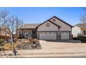 Inviting home featuring a two-car garage, manicured lawn, and delightful curb appeal in a suburban setting at 21142 Hawthorne Ln, Parker, CO 80138