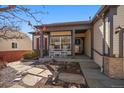 Charming front porch with rocking chairs, complemented by a beautifully landscaped yard and welcoming entrance at 21142 Hawthorne Ln, Parker, CO 80138