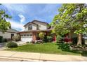 Charming two-story home featuring a well-kept lawn, a two-car garage, and mature trees surrounding the property at 2912 Lake Park Way, Longmont, CO 80503