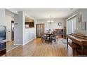 Bright dining area with hardwood floors, a chandelier, a decorative cabinet and natural light at 5506 S Quemoy Cir, Aurora, CO 80015