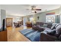 Inviting living room with hardwood floors, a cozy gray couch, and lots of natural light at 5506 S Quemoy Cir, Aurora, CO 80015