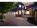 Striking two-story home with a stone turret, a two-car garage, and a wide concrete driveway at 2832 Danbury Ave, Highlands Ranch, CO 80126