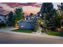 Attractive multi-story home with stone accents and a professionally landscaped front yard at 2832 Danbury Ave, Highlands Ranch, CO 80126