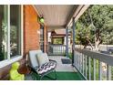 Cozy front porch featuring comfortable seating, brick accents, and a view of the neighborhood street at 511 S Pennsylvania St, Denver, CO 80209
