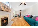 Spacious living room with hardwood floors, decorative fireplace, ceiling fans, and comfortable seating at 511 S Pennsylvania St, Denver, CO 80209