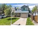 Quaint two-story home featuring a well-kept lawn, driveway, and basketball hoop for recreational enjoyment at 13323 Birch Cir, Thornton, CO 80241