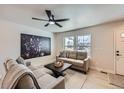 Comfortable living area with modern ceiling fan, lots of natural light, and neutral decor at 1896 Hogan Ct, Castle Rock, CO 80109