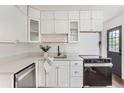 Modern kitchen with white cabinets, stainless steel appliances, and subway tile backsplash at 1557 North St, Boulder, CO 80304