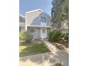 Charming two-story townhome with newly installed gray siding, manicured landscaping, and a welcoming front walkway at 56 S Nome St, Aurora, CO 80012