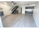 Bright living room features modern floors, fireplace, adjacent stairway, and a sleek breakfast bar at 56 S Nome St, Aurora, CO 80012