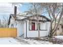 Updated white brick home with red door and walkway at 1209 Harrison St, Denver, CO 80206