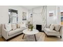 Bright living room features a modern marble fireplace, neutral decor, and ample natural light at 1209 Harrison St, Denver, CO 80206