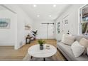 Open-concept living area with hardwood floors, a stylish couch, and a sliding barn door adding character at 1209 Harrison St, Denver, CO 80206