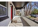 Inviting covered front porch with brick pillars and a 'Welcome' mat, adding character to the entrance at 1209 Harrison St, Denver, CO 80206