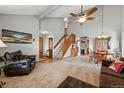 Open living room boasts vaulted ceilings, a staircase, and ample natural light at 4014 S Kirk Way, Aurora, CO 80013