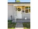Inviting front door with decorative wreath and charming porch, showing curb appeal at 98 N 12Th Ave, Brighton, CO 80601
