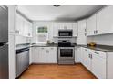 Well-lit kitchen featuring white cabinetry, stainless steel appliances, and granite countertops at 98 N 12Th Ave, Brighton, CO 80601