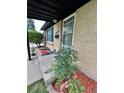 Cozy front porch featuring a brick house and manicured landscaping at 3000 Billings St, Aurora, CO 80011