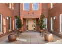 Inviting Swallow Hill entrance with mature landscaping, seating, and brick architecture at 1631 N Emerson St # 407, Denver, CO 80218