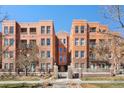 Charming brick condominium building with wrought iron gates and professionally landscaped grounds at 1631 N Emerson St # 407, Denver, CO 80218