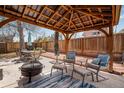 Outdoor patio with covered pergola, creating a comfortable entertaining space at 6445 Second St, Louviers, CO 80131