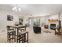 Bright living room featuring neutral carpet, fireplace, and large glass doors leading to outdoor space at 23612 Pondview Pl # A, Golden, CO 80401