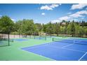 Brightly painted tennis courts with surrounding greenery, providing an inviting recreational space at 23612 Pondview Pl # A, Golden, CO 80401