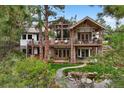 Beautiful multi-level home with stone accents, balconies, and a well-manicured lawn at 646 Ruby Trust Dr, Castle Rock, CO 80108