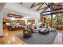 Spacious living room with vaulted ceilings, large windows, and an open floor plan with a modern kitchen at 646 Ruby Trust Dr, Castle Rock, CO 80108