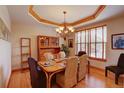 Classic dining room with hardwood floors, elegant chandelier, and large window providing natural light at 2941 Castle Butte Drive Dr, Castle Rock, CO 80109