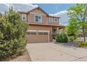 Charming two-story home featuring a two-car garage, a landscaped front yard, and a welcoming facade at 2908 Open Sky Way, Castle Rock, CO 80109