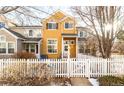 Attractive two-story townhome with a white picket fence at 911 Snowberry St, Longmont, CO 80503