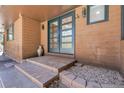 Charming home entrance with double doors and brick steps at 8782 S Ault Ln, Morrison, CO 80465