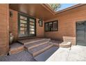 Charming home entrance with double doors and brick steps at 8782 S Ault Ln, Morrison, CO 80465