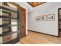Light filled entryway with wood floors, wood accents, and view to other rooms at 8782 S Ault Ln, Morrison, CO 80465