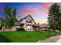 Attractive home with a well-maintained lawn, brick and stone accents, and a welcoming facade at 17053 E Jamison Ave, Centennial, CO 80016