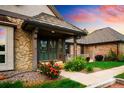 Close-up of the front entrance with stone accents and well-maintained landscaping at 17053 E Jamison Ave, Centennial, CO 80016