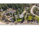 An aerial view shows the property near a flowing creek, offering scenic views at 41 Silver Spruce, Boulder, CO 80302