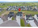 Aerial view of residential neighborhood with mountain backdrop and red location pin at 1172 Elbridge Cir, Elizabeth, CO 80107