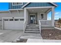 Covered front porch leads to the front door, three car garage on the left at 1172 Elbridge Cir, Elizabeth, CO 80107