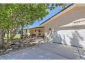 Beautiful home with a red door, manicured lawn, mature trees, and a two-car garage at 5583 Thunder Hill Rd, Parker, CO 80134