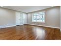 Bright living room with hardwood floors, large bay window, and fresh paint at 5500 Holland Dr, Arvada, CO 80002