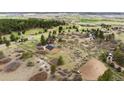 Expansive aerial view of the home and surrounding acreage with a separate garage at 7465 Kelty Trl, Franktown, CO 80116