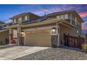 Angle of the house showing the driveway leading to the 2-car garage and the sidewalk leading to the front door at 1933 Griffin Dr, Brighton, CO 80601
