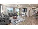 Bright and airy living room with hardwood floors, fireplace, large window and glass door to let in the natural light at 1933 Griffin Dr, Brighton, CO 80601